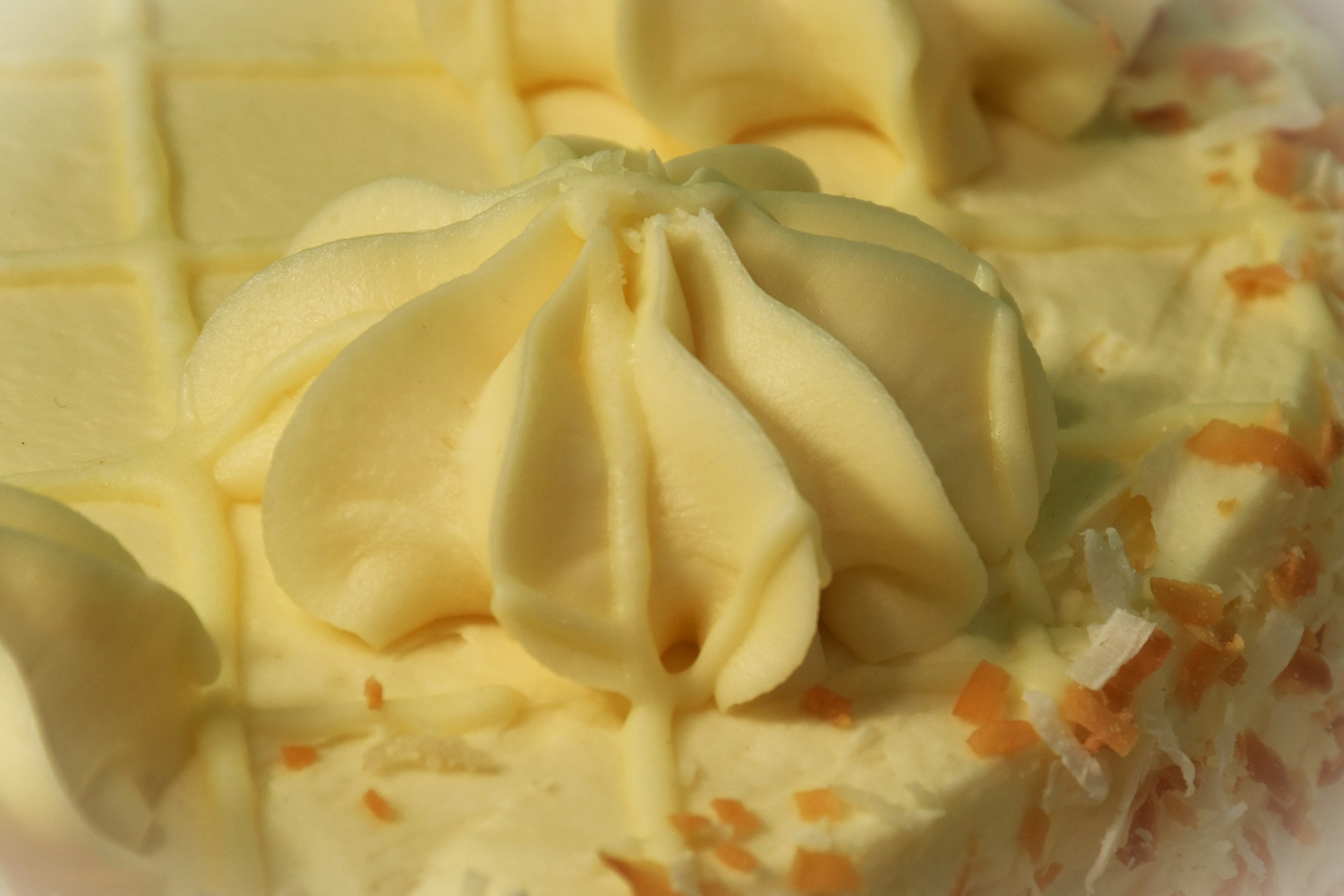 Close-up of a frosted celebration cake with piped buttercream